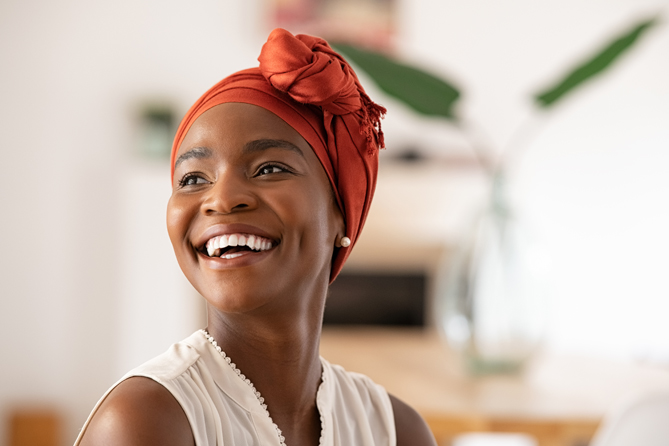 Joyful mature african woman laughing and looking away