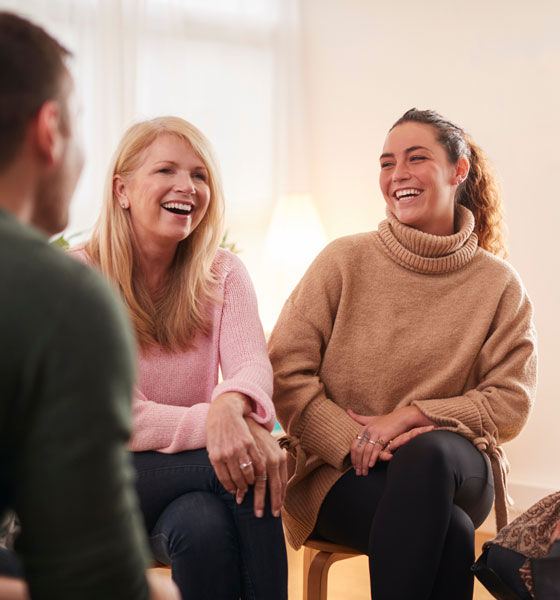 People laughing while attending a support group meeting