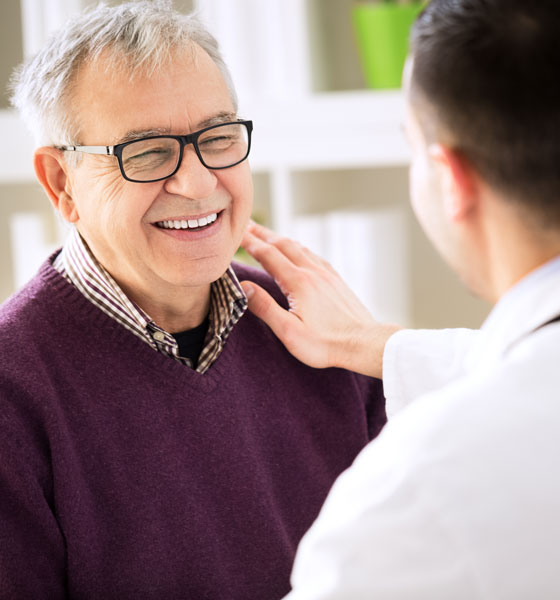 Doctor encouraging an elderly male patient