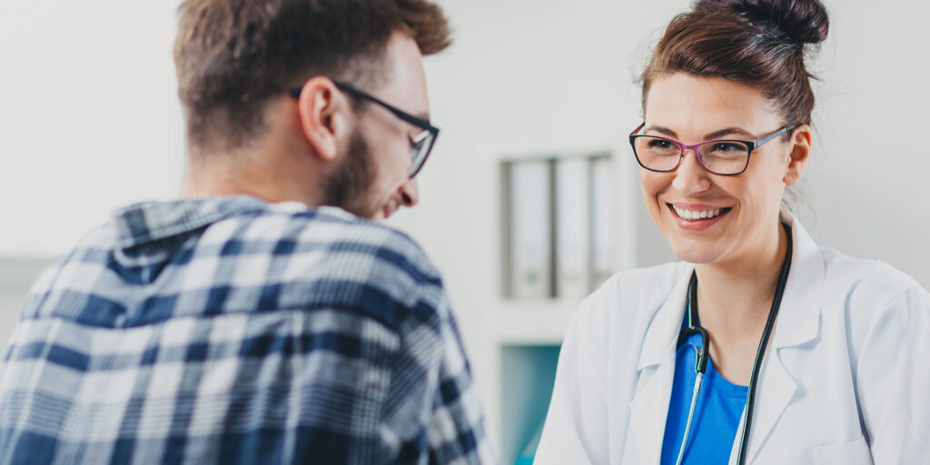 Female doctor smiling talking to patient