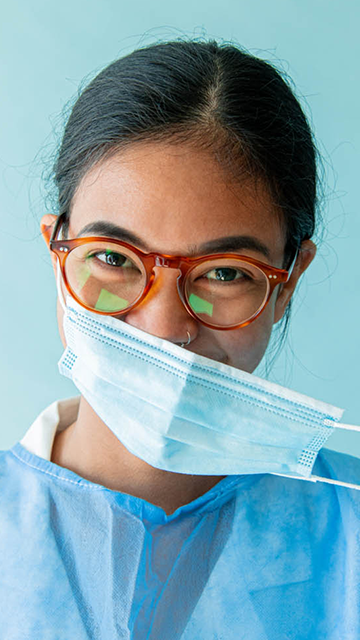 Closeup shot of a female doctor wearing glasses and a mask to represent CareFlow