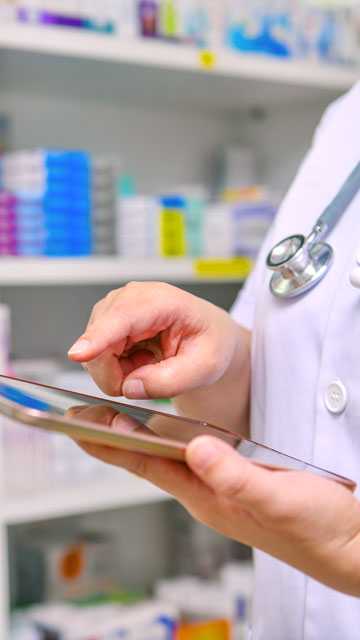 Doctor using tablet in a pharmacy