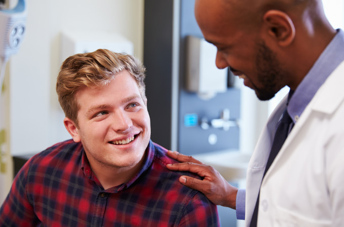 Young male smiling at doctor